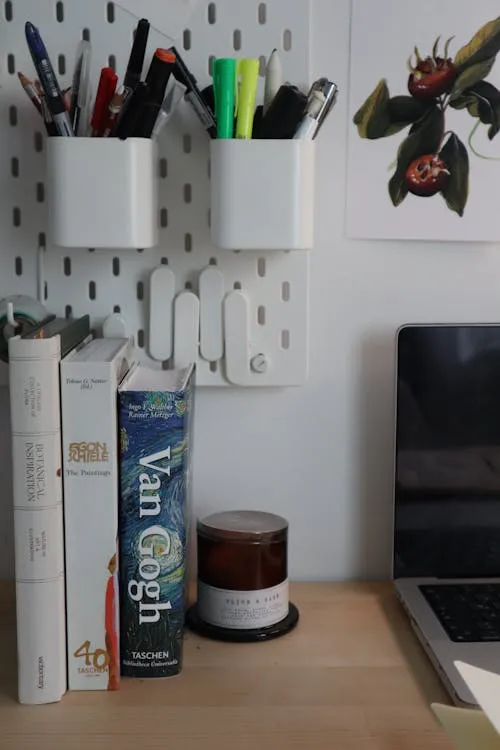 Organized home office desk with stationery, books, and a laptop, representing structured workspaces for AI projects.