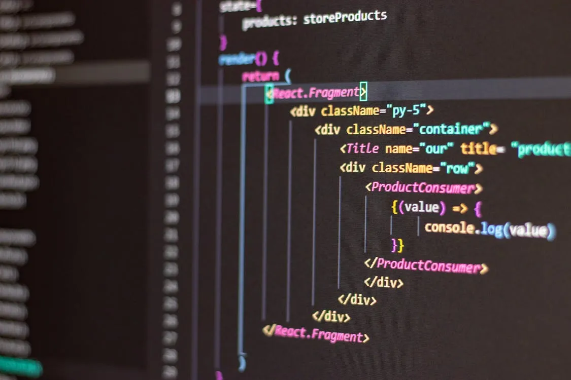 Dark monitor displaying lines of programming code, representing a developer terminal running an AI coding agent.